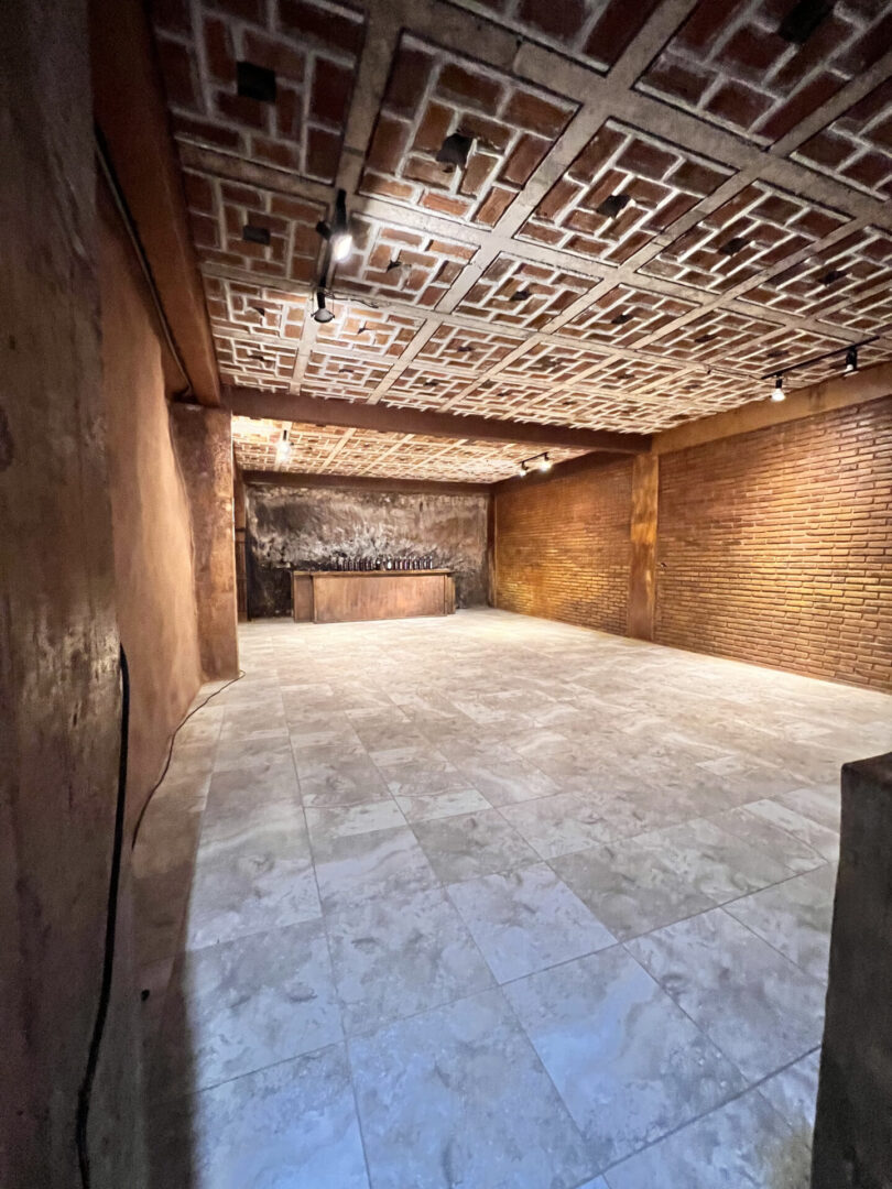 A room with a brick wall and a ceiling