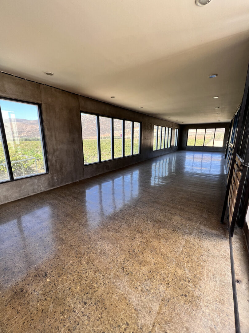 A large room with many windows and a tiled floor.