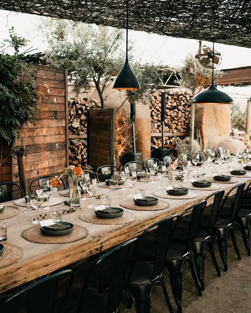 A long table with plates and glasses on it