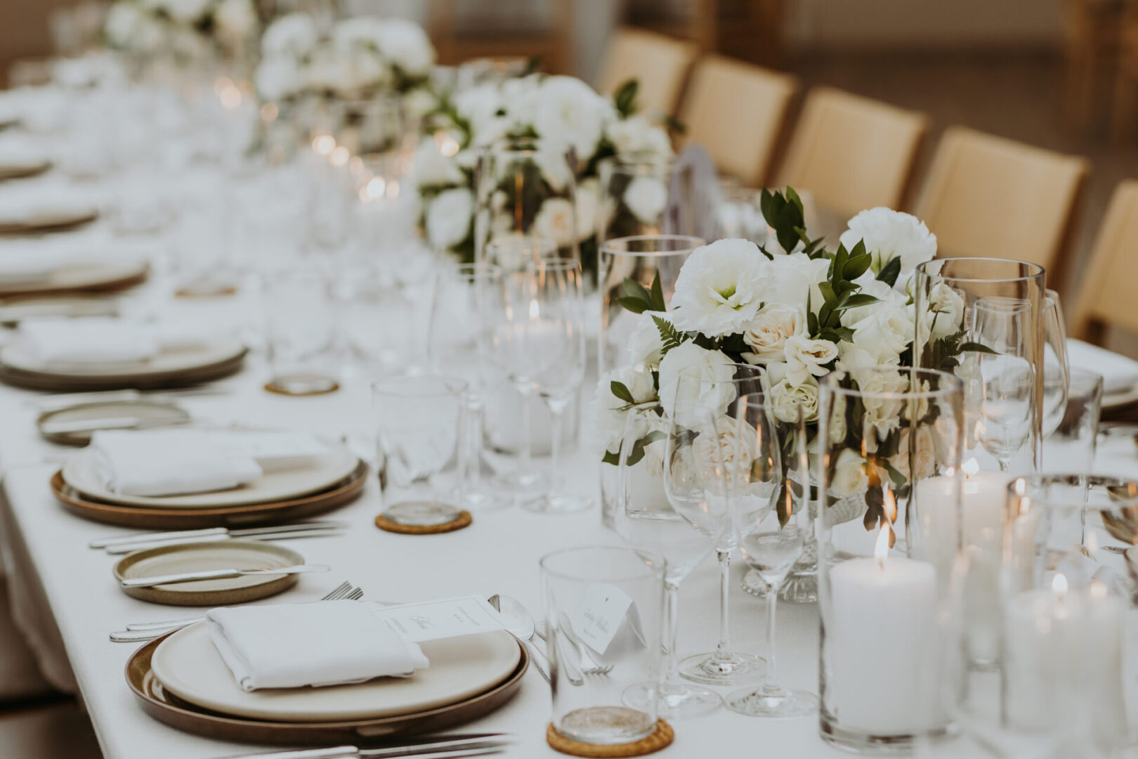 A long table with white flowers and plates