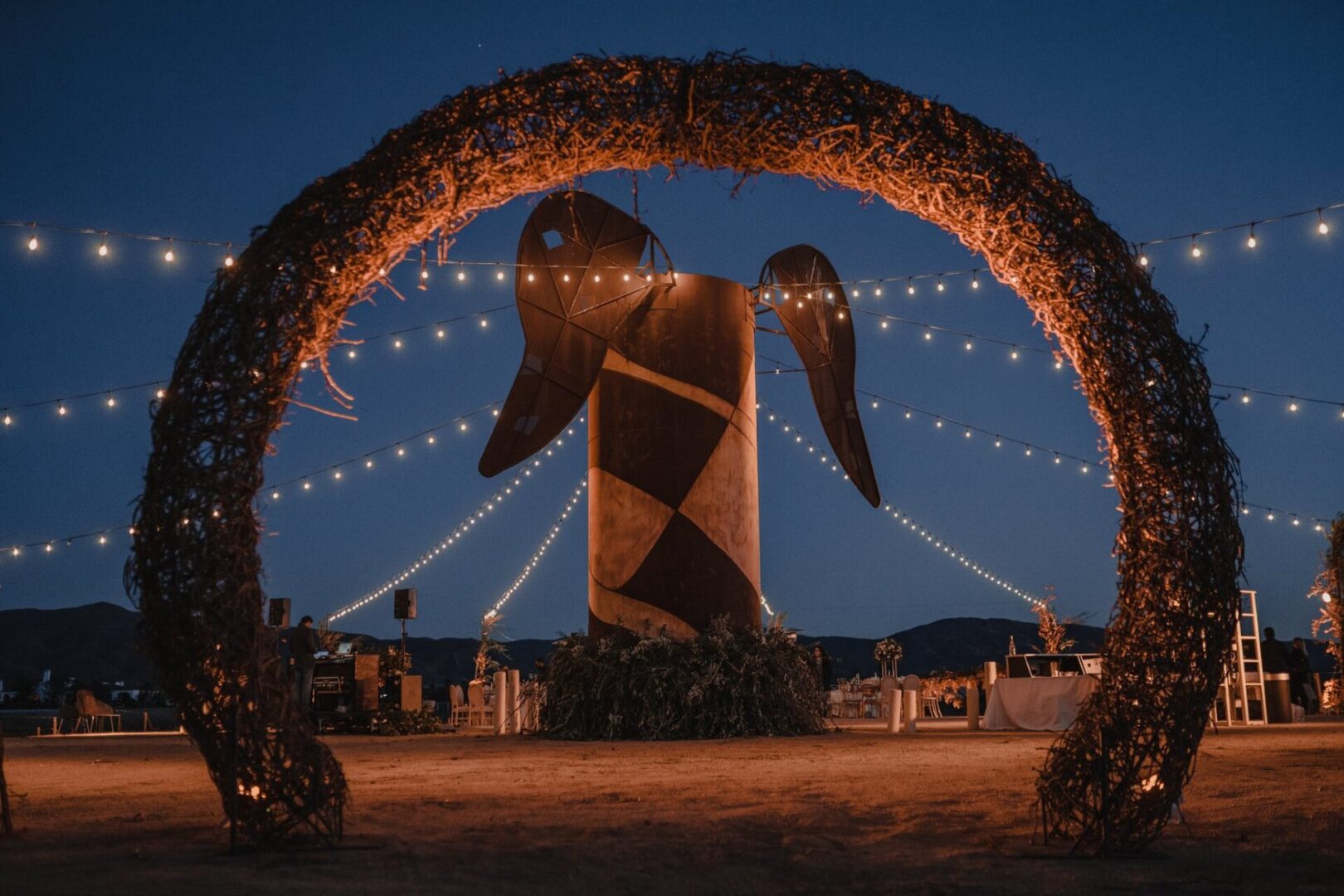 A large sculpture of an animal in the middle of a field.