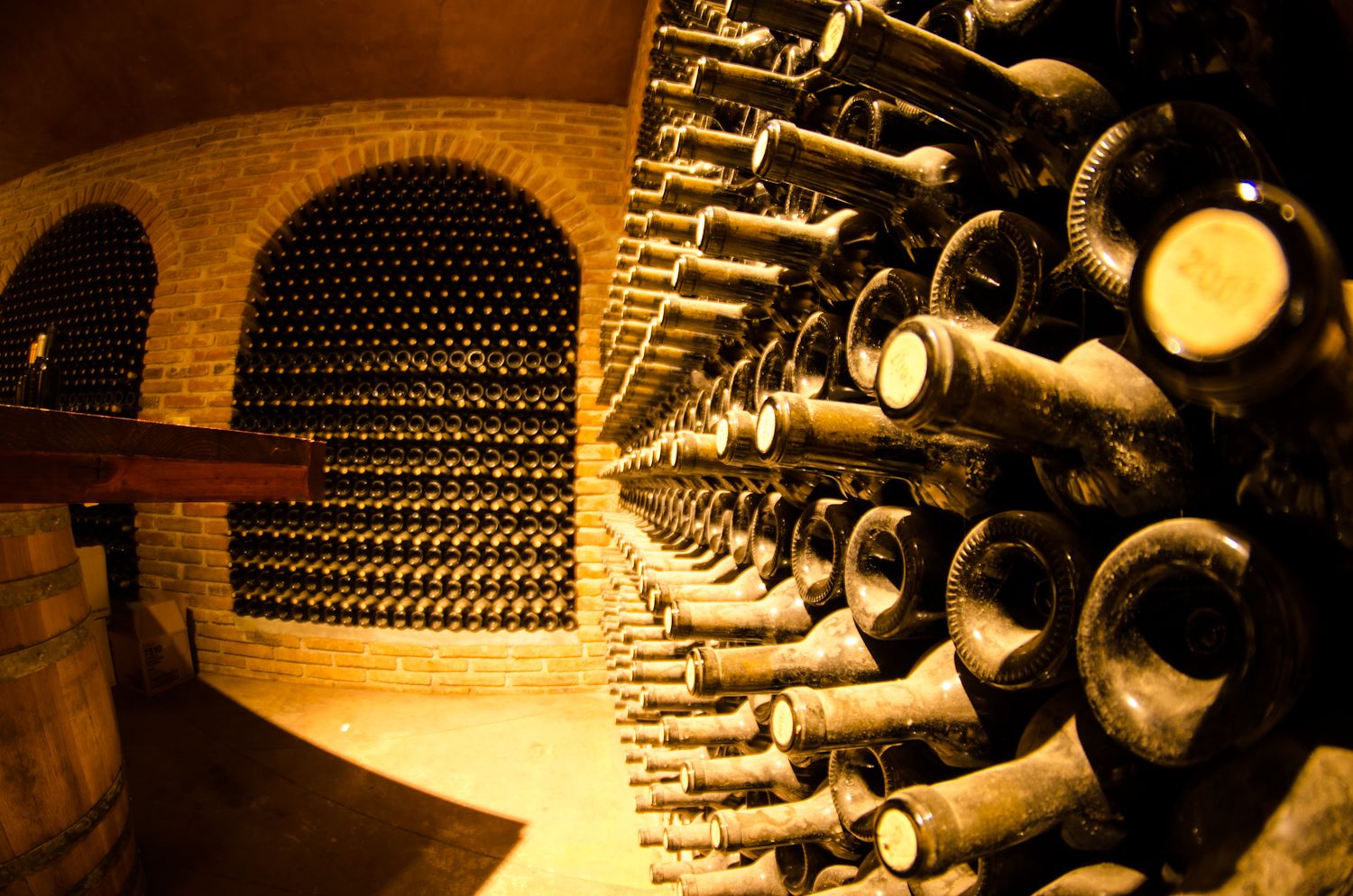 A bunch of bottles in a wine cellar