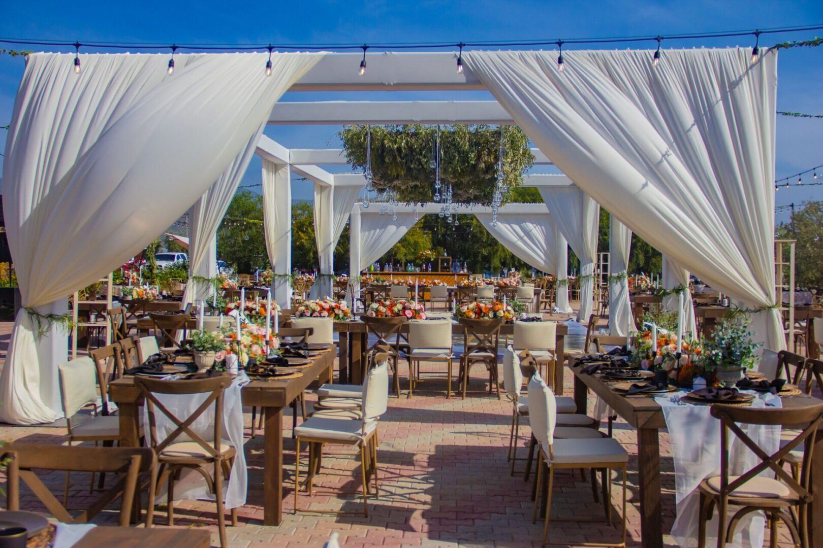 A large outdoor event with tables and chairs.