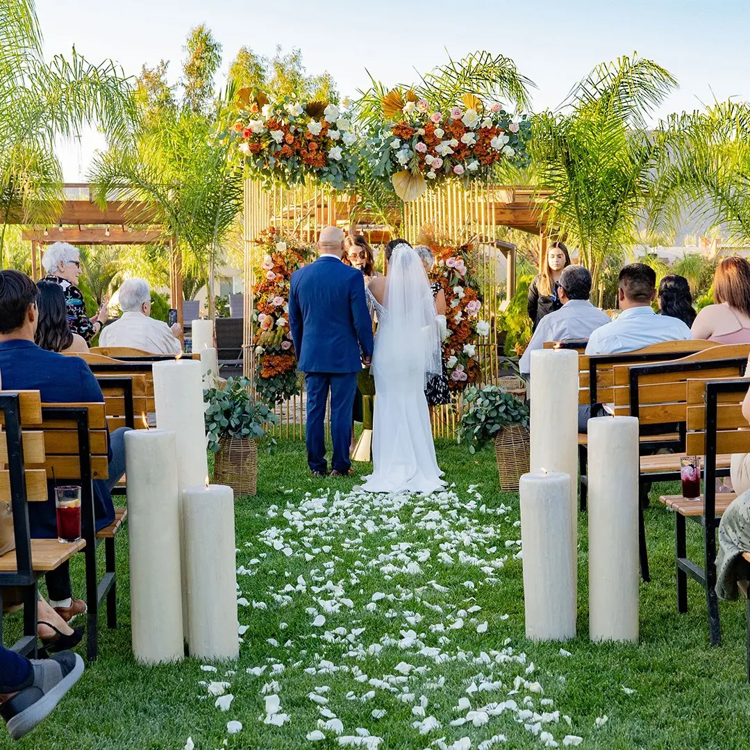 A couple getting married in an outdoor ceremony.